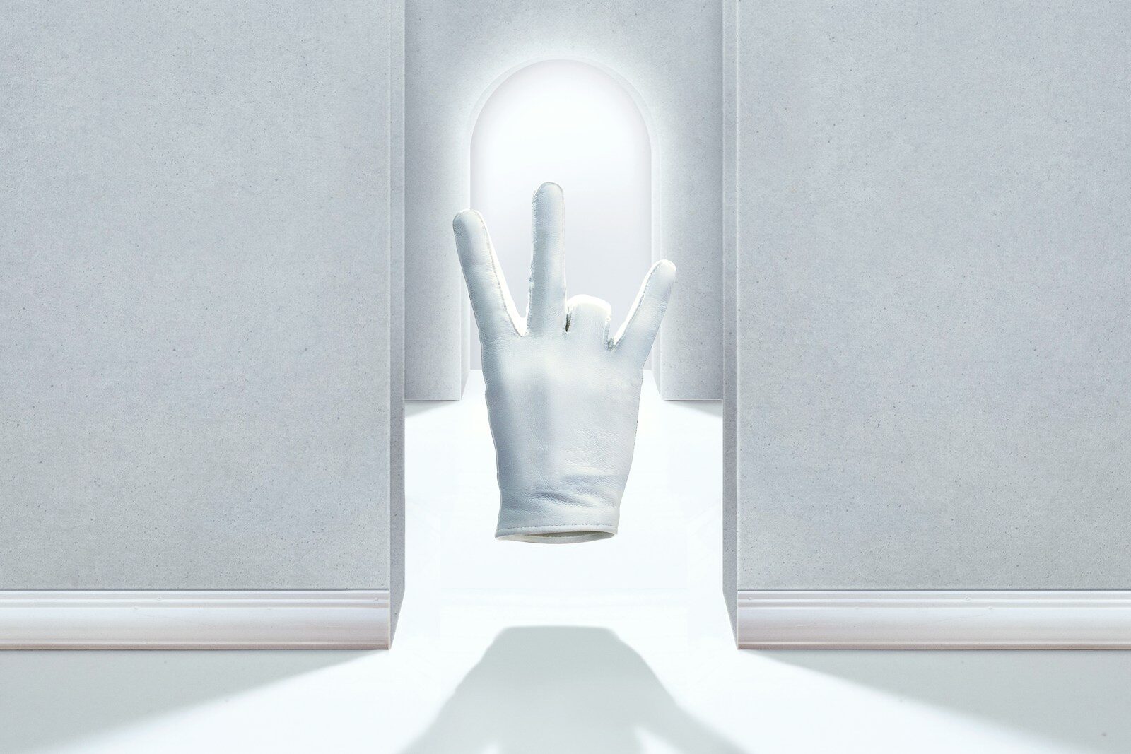 a person's hand reaching out of a doorway